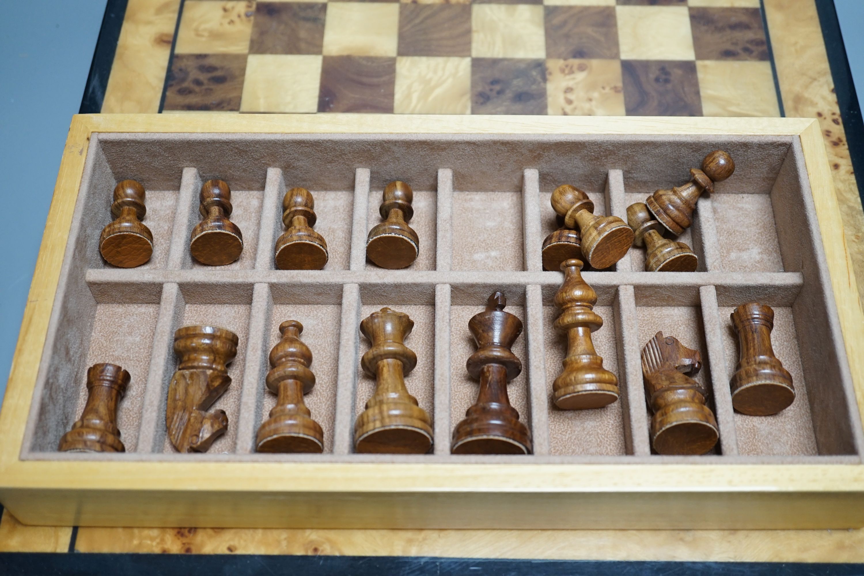 A cased Backgammon set and a chess set with chess-board top and drawers for chess pieces, chess box 35.5 cms x 35.5 cms.
